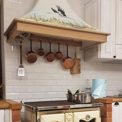 Big cooker hood with stork painting and wooden frame.