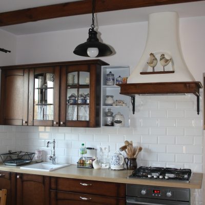 Dark framed, handcrafted cooker hood with shelf.